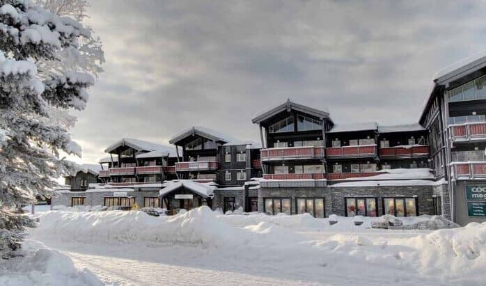 Ski-in/ski-out chalet exterior with private balconies and ground-floor gear shop