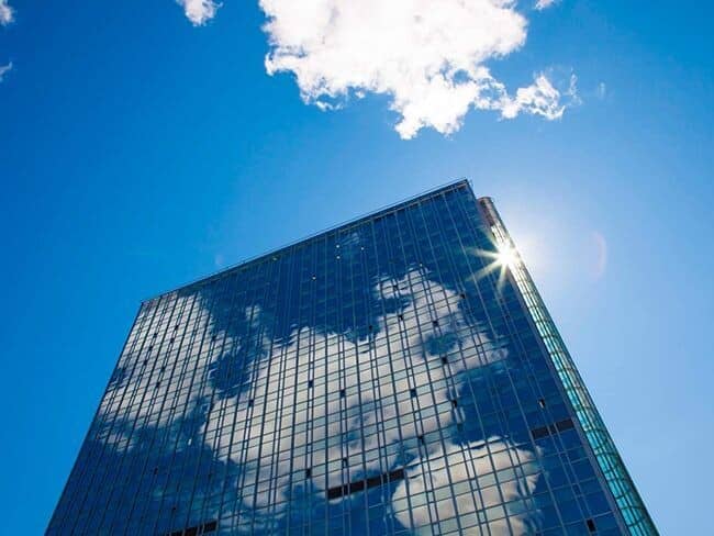 Glass high-rise exterior with reflective facade and operable windows