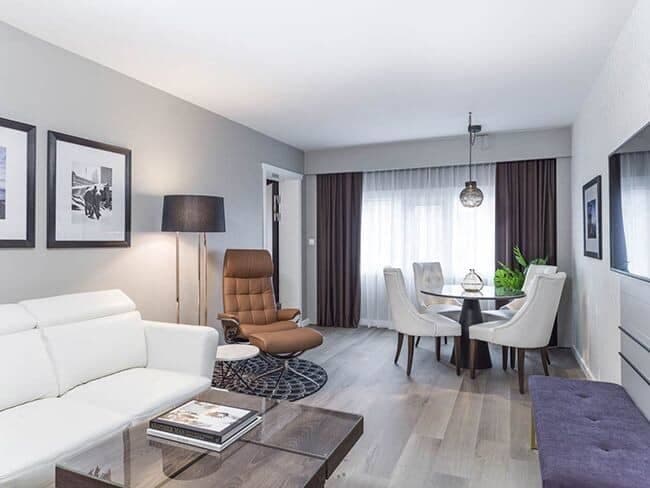 Open living area with four-person dining table and blackout curtains