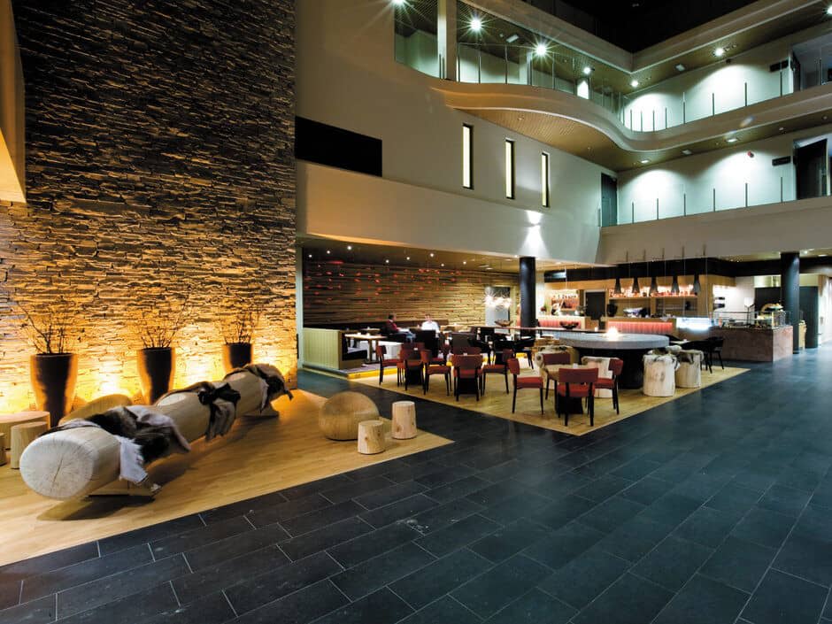 Atrium lobby bar and restaurant with fireplace and tiered gallery seating