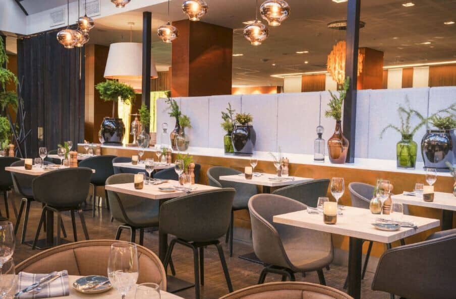 Dining area with cafe-style seating for two and curated glass bottle decor