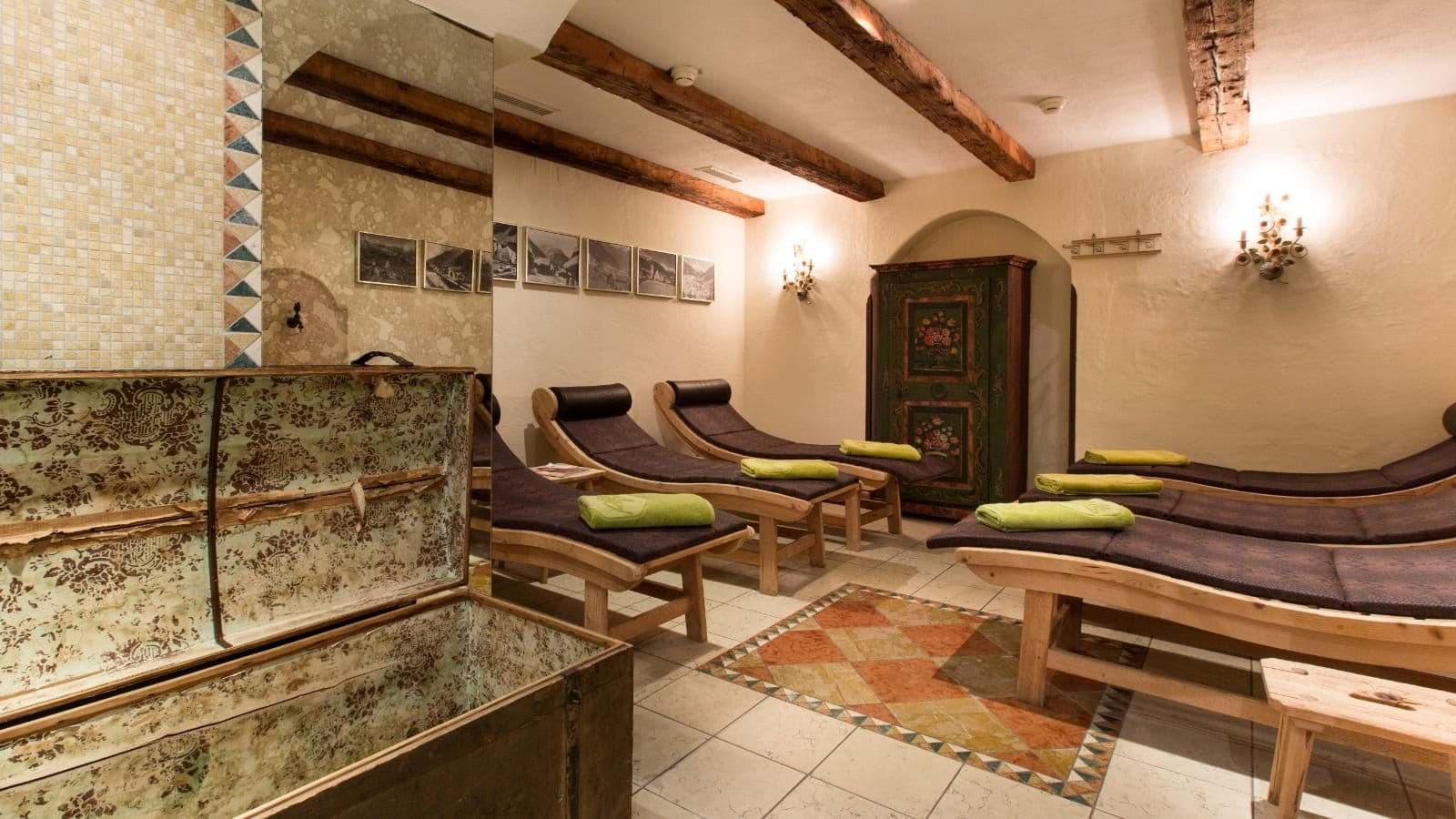 Spa relaxation room with five heated ergonomic loungers and exposed ceiling beams