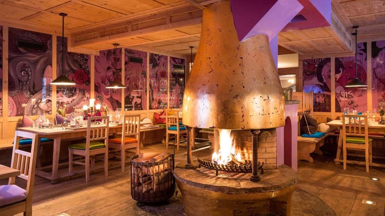 Dining area with wood-burning fireplace and booth seating