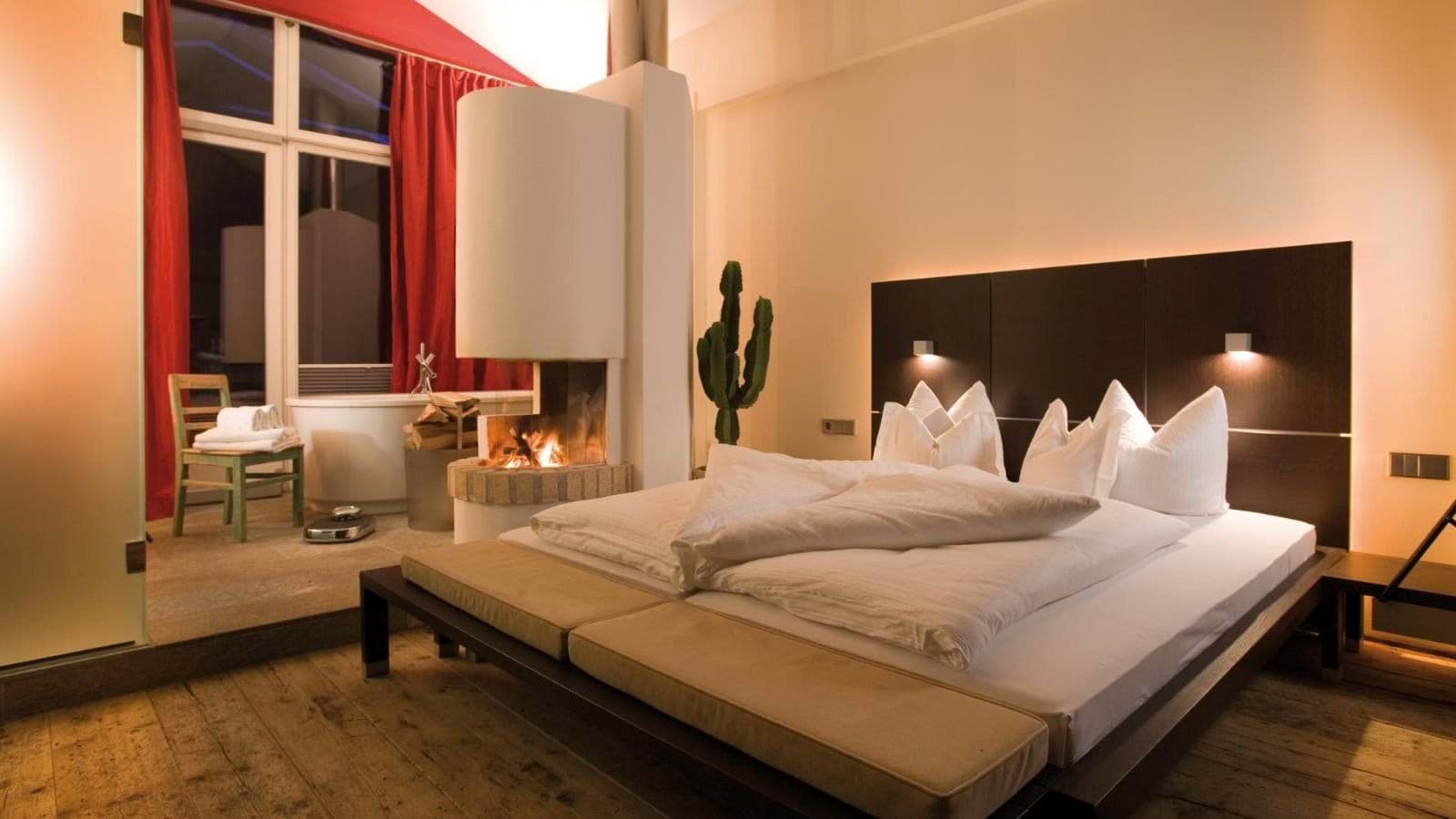 Primary bedroom with double-sided fireplace and en-suite soaking tub