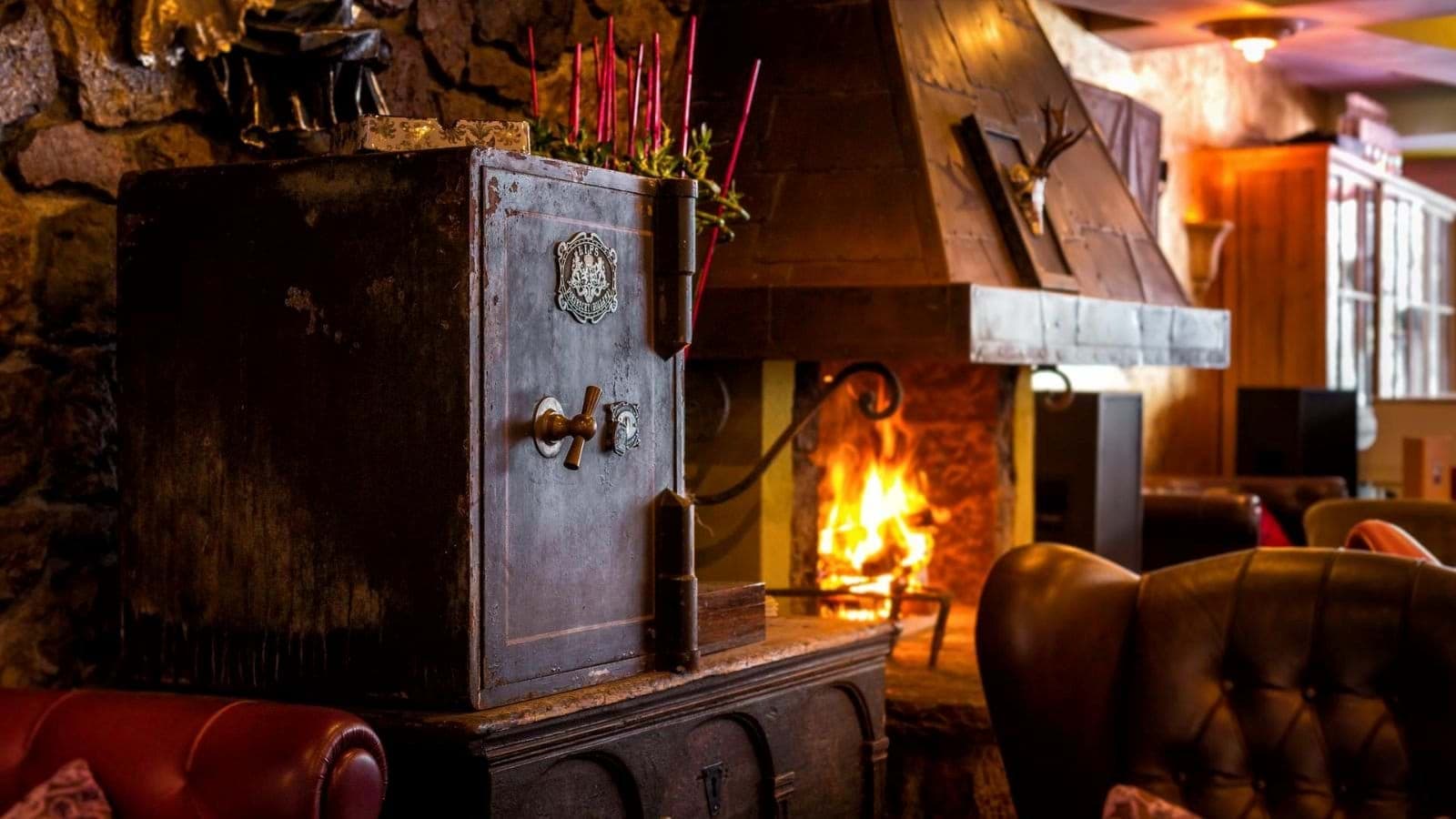 Lounge area with wood-burning fireplace and antique iron safe