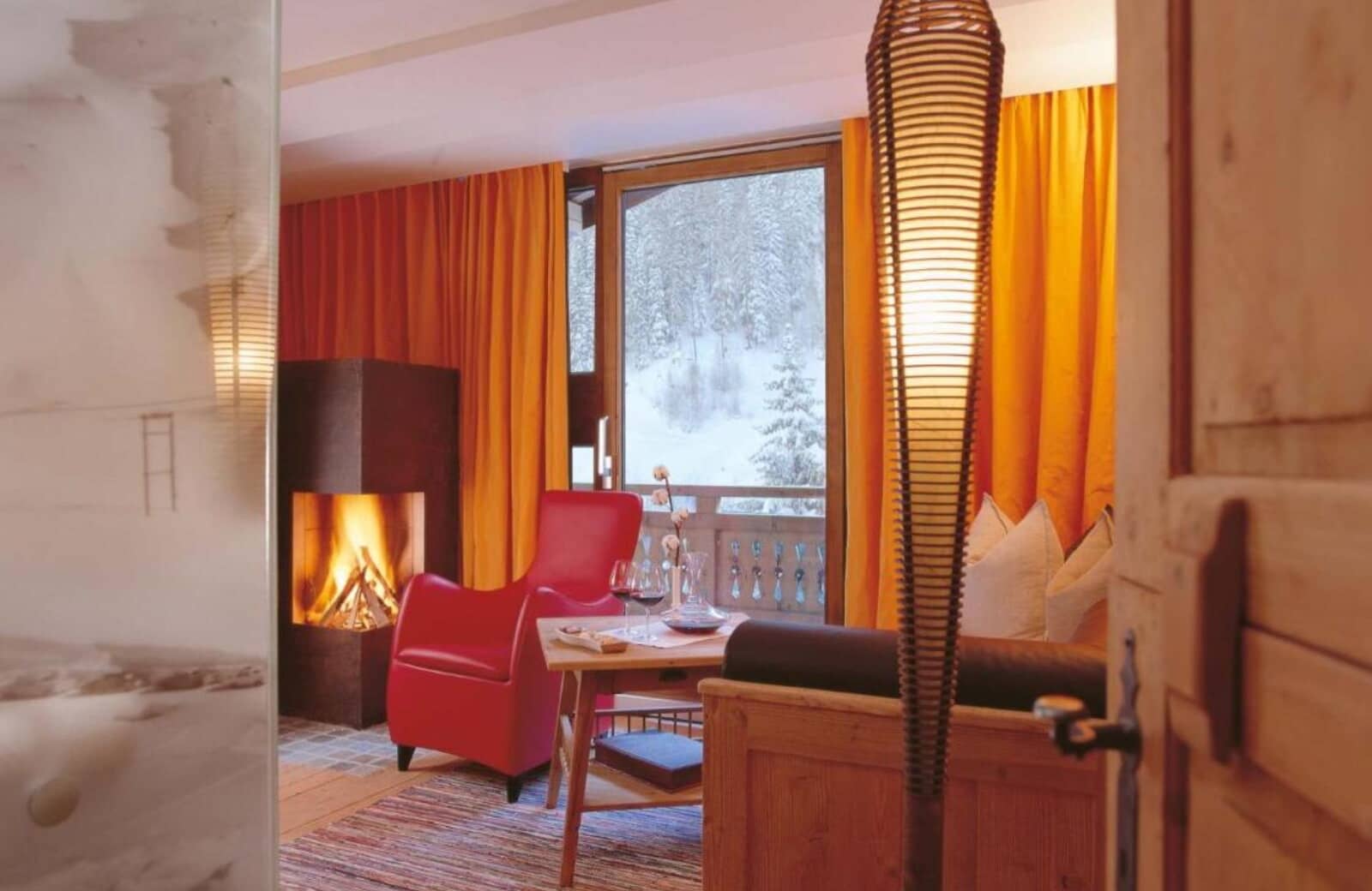 Seating area with wood-burning fireplace and private balcony access