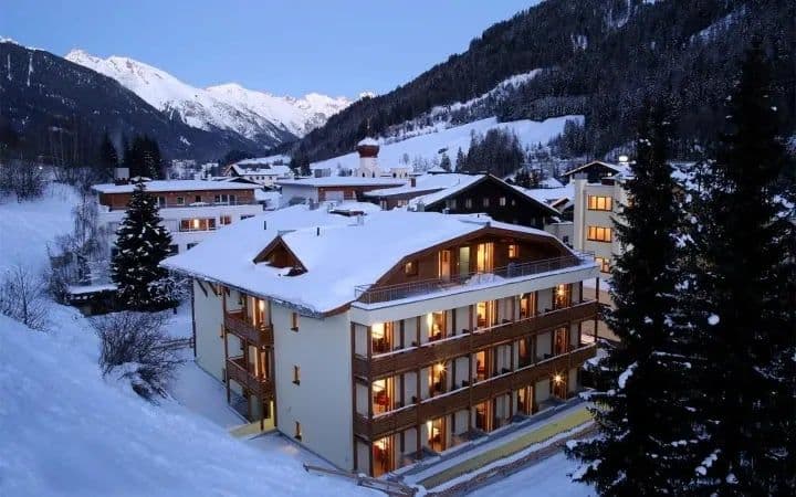 Chalet exterior featuring private balconies and panoramic alpine mountain views