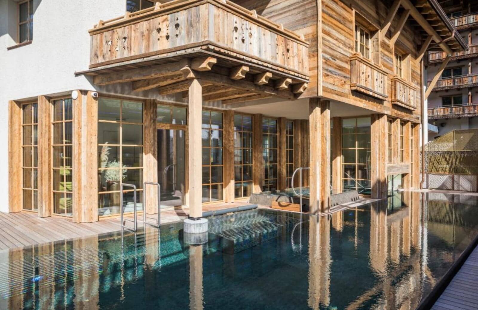 Outdoor infinity pool with swim-in access and stainless steel stairs