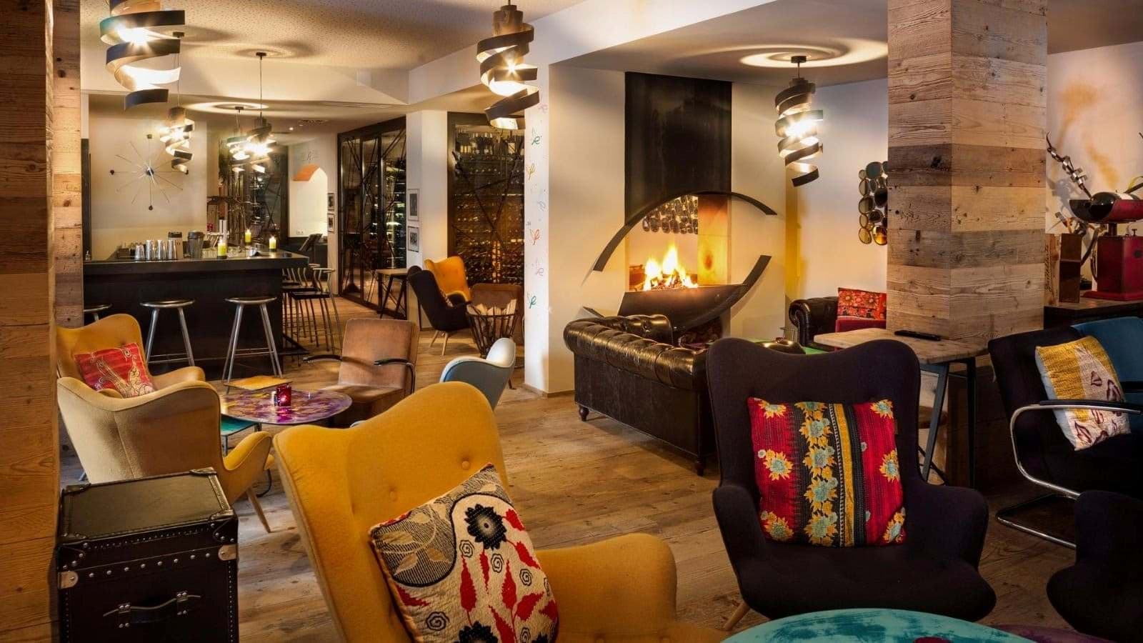 Lounge with wood-burning fireplace, bar seating, and walk-in wine cellar