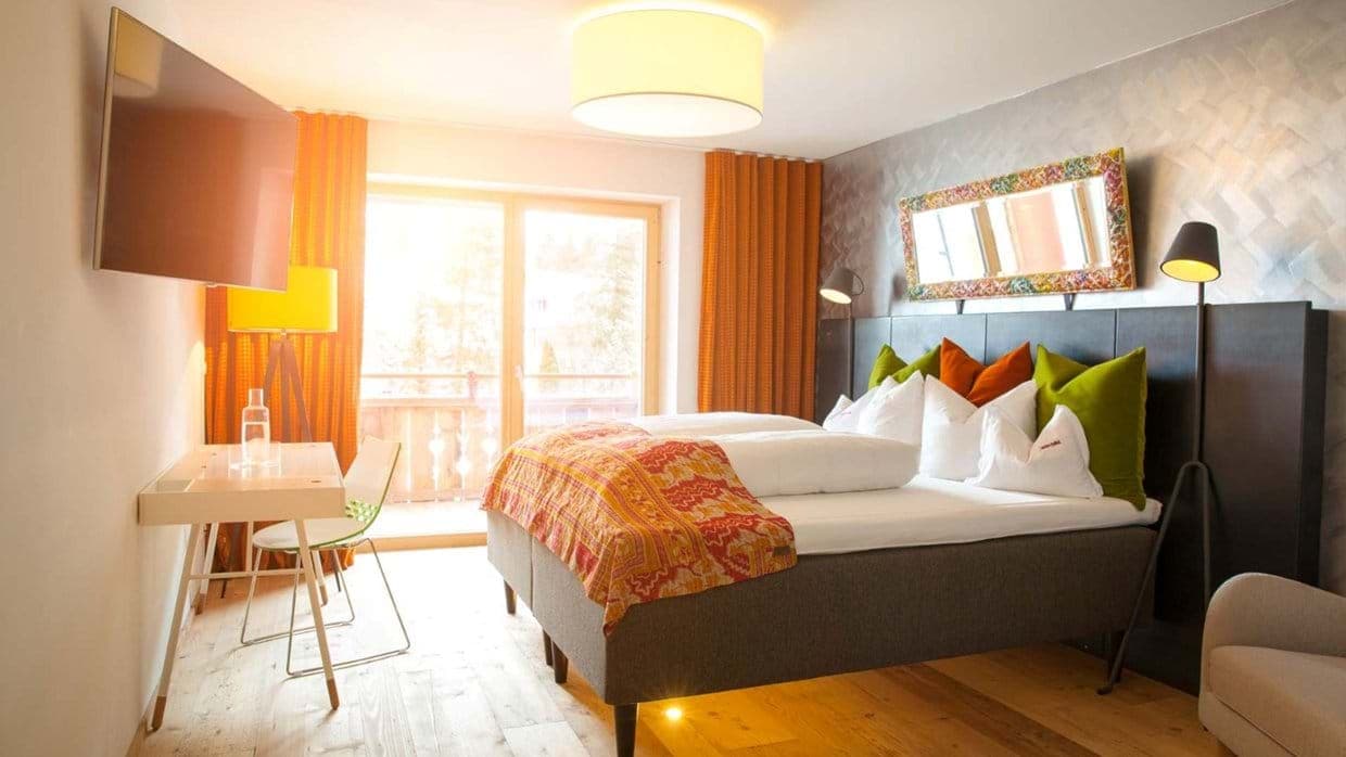 Bedroom with king bed, dedicated workspace, and balcony access