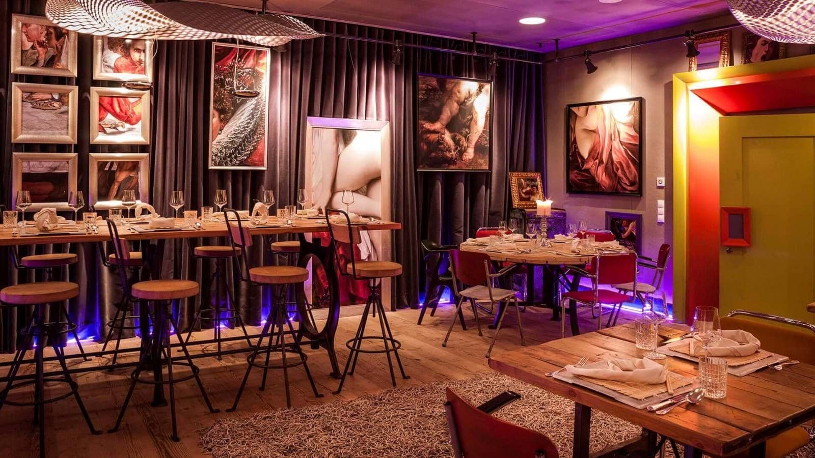 Dining area with bar-height seating and several tables for groups