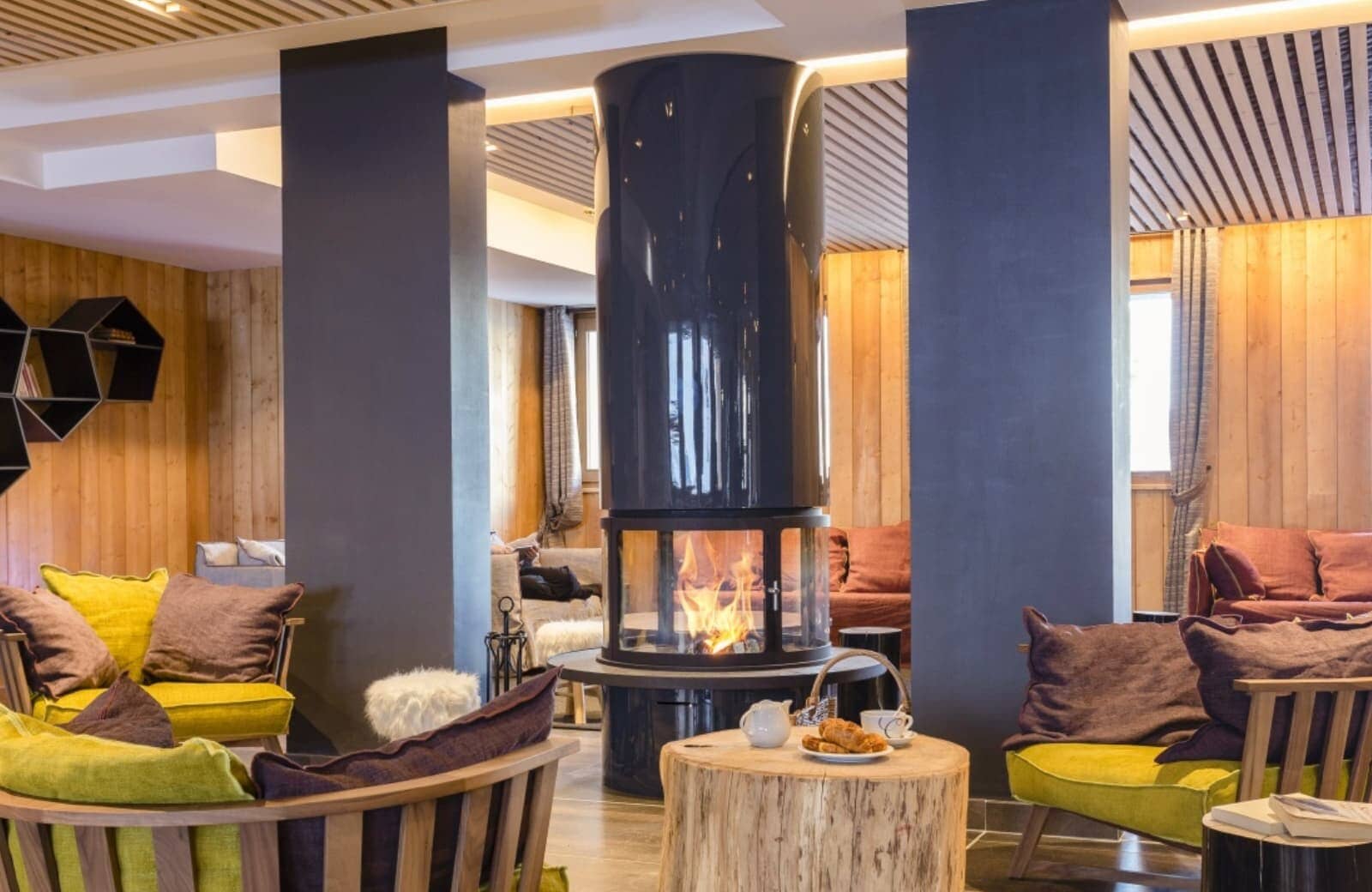 Shared lounge featuring 360-degree central fireplace and wood-paneled walls
