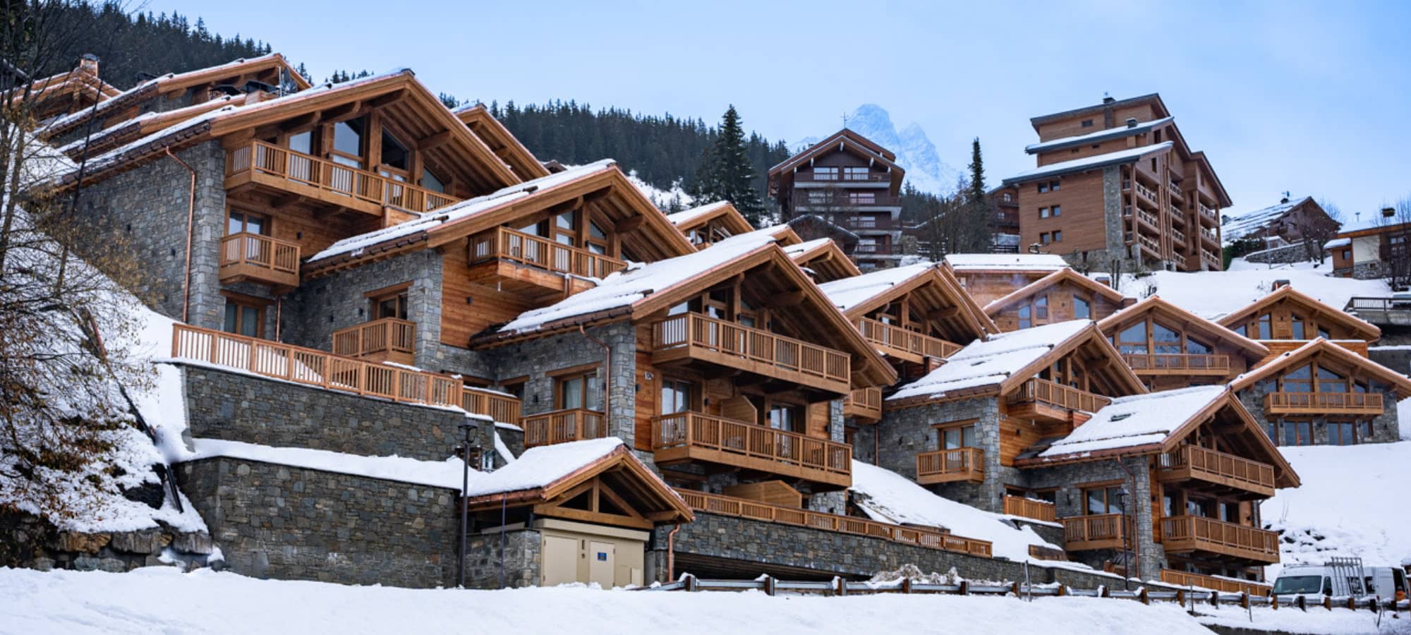 Mountain-side chalets with private balconies and stone construction