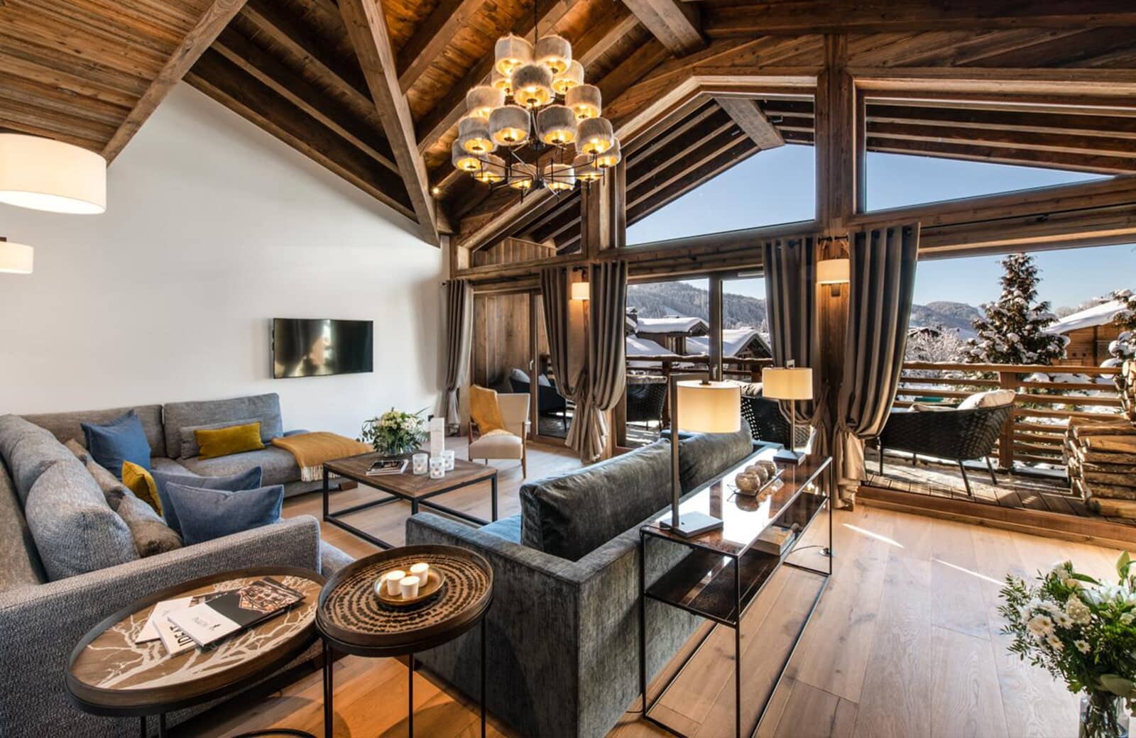 Living room with vaulted wood ceilings and floor-to-ceiling mountain views