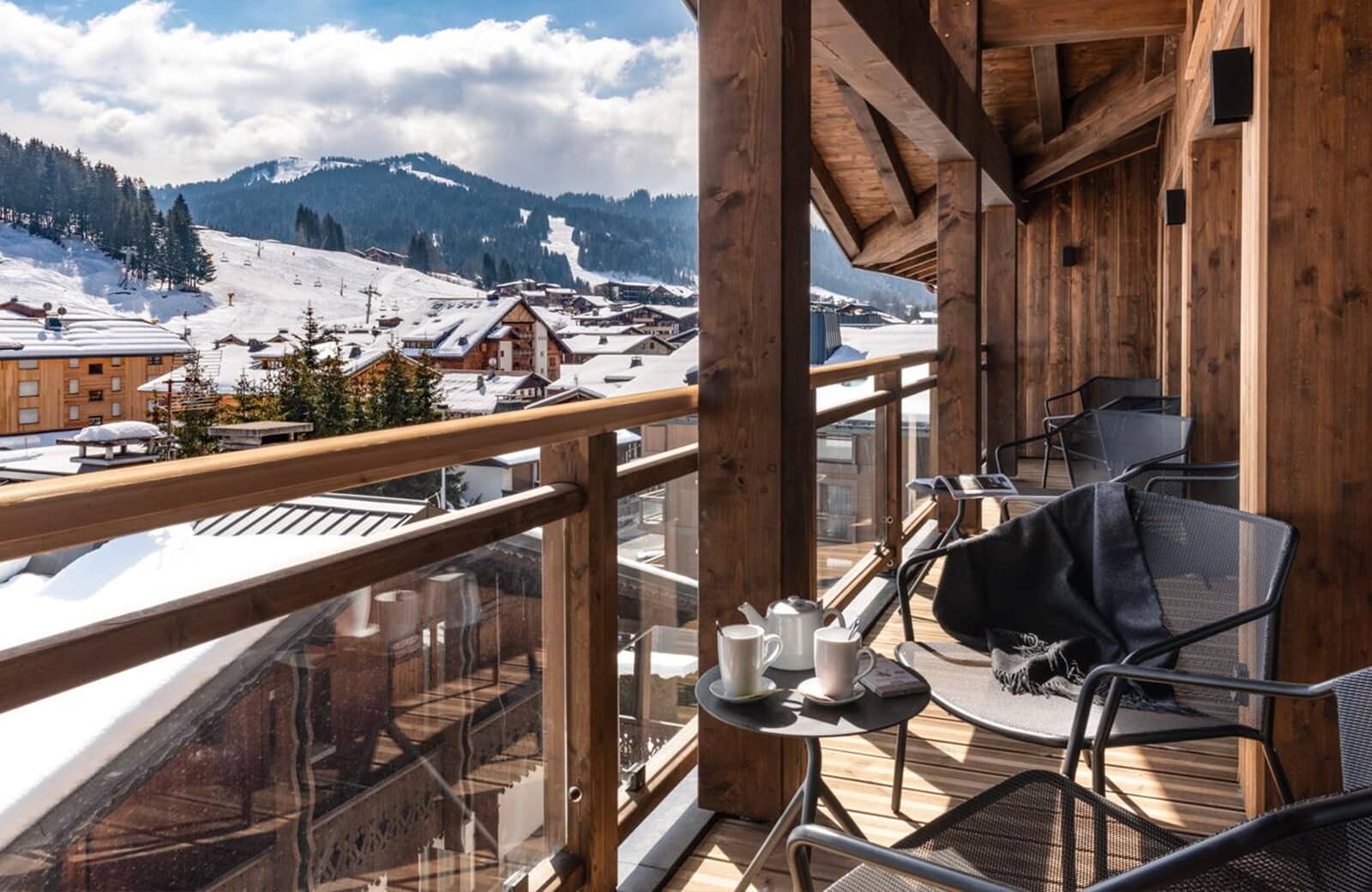 Covered balcony with seating and ski slope views