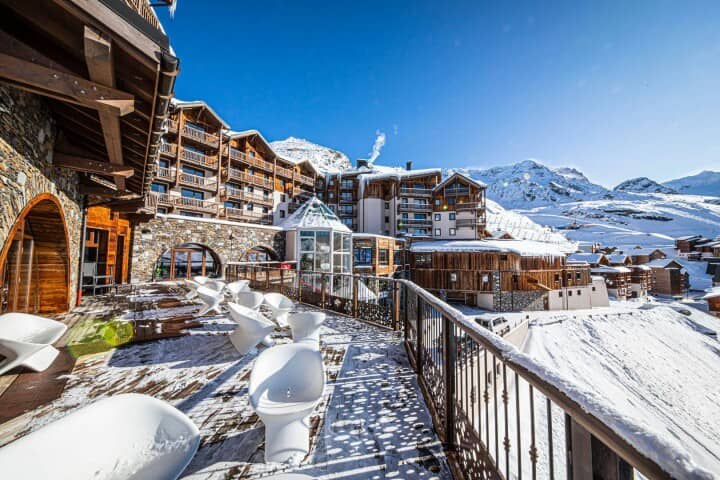 Shared terrace with lounge chairs and ski village views