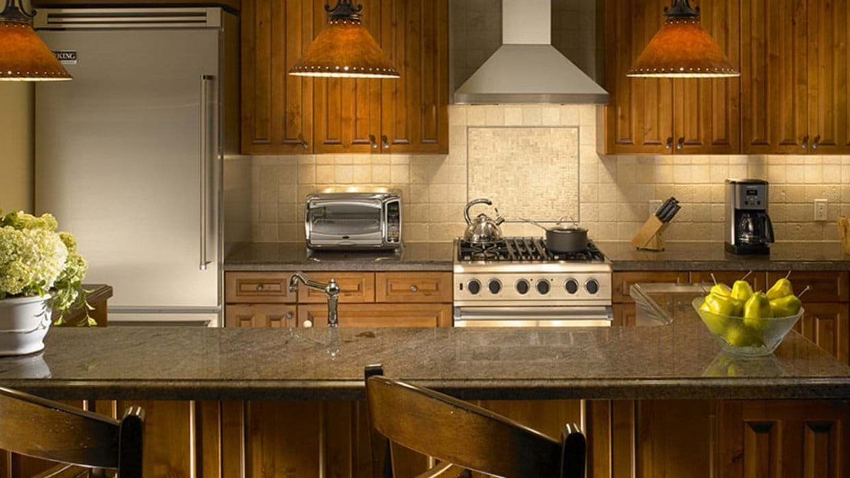 Kitchen with Viking refrigerator, gas range, and breakfast bar seating