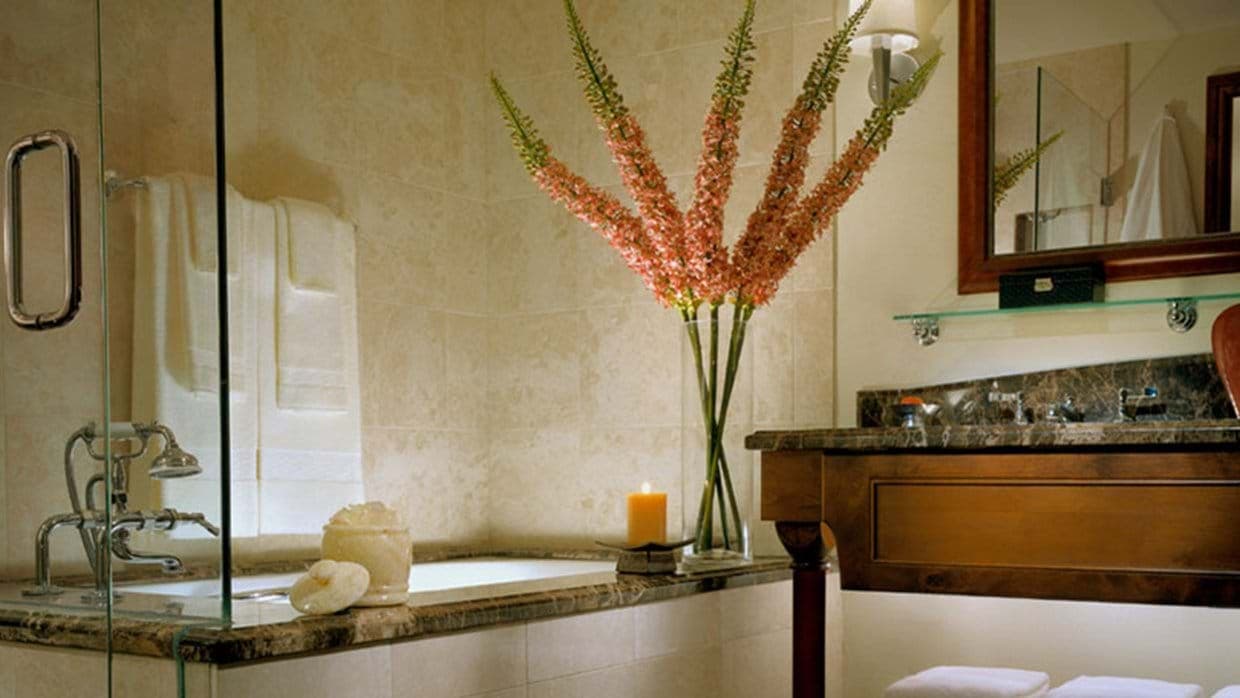 Bathroom with soaking tub and marble-topped vanity