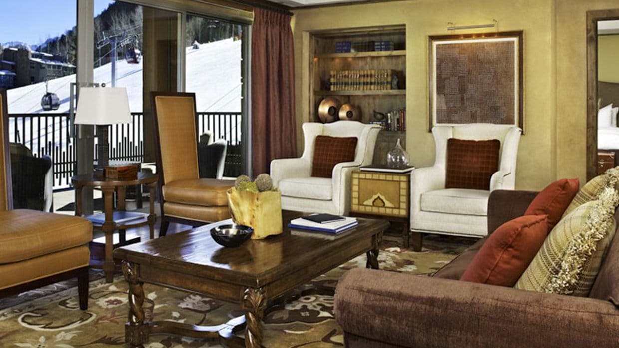 Living area with balcony access and views of the ski gondola