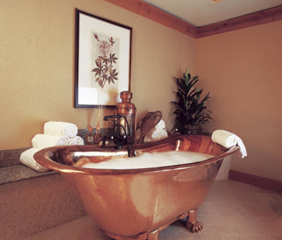 Bathroom with copper clawfoot soaking tub and granite ledge