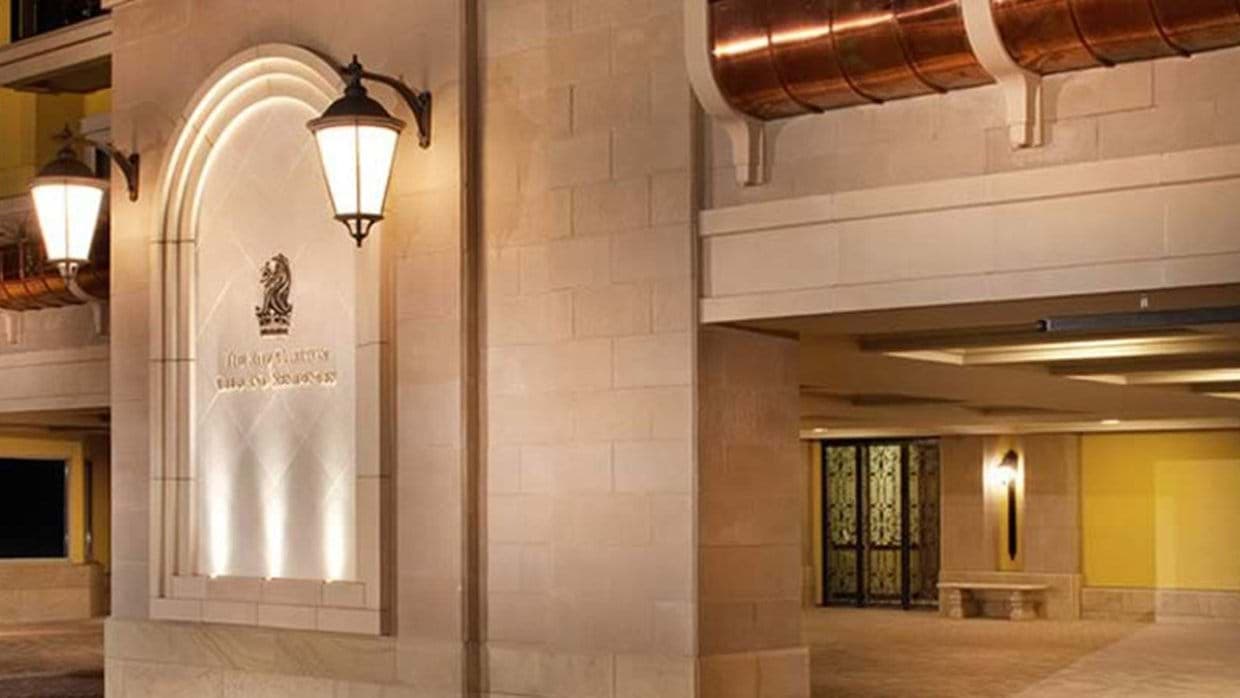 Building entrance with covered porte-cochère and copper accents