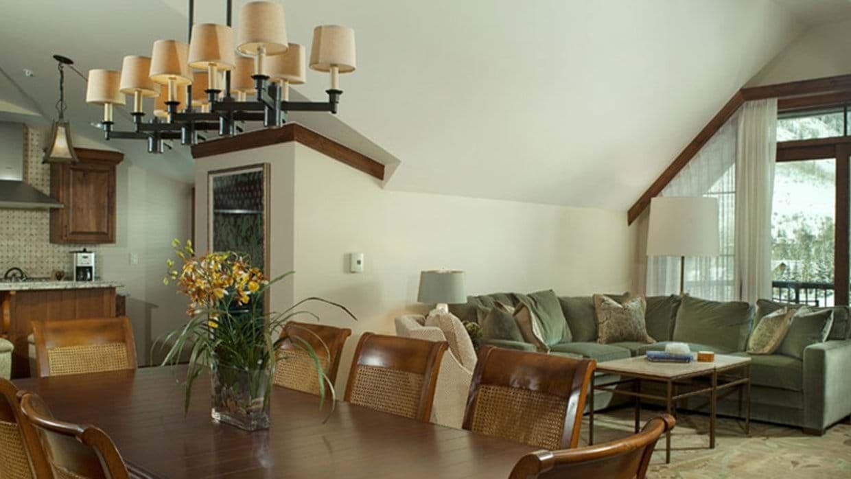 Open living area with dining for 8 and mountain-view balcony