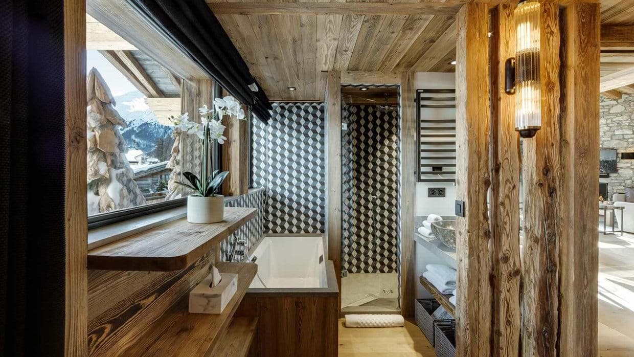 Bathroom with soaking tub, heated towel rail, and mountain views
