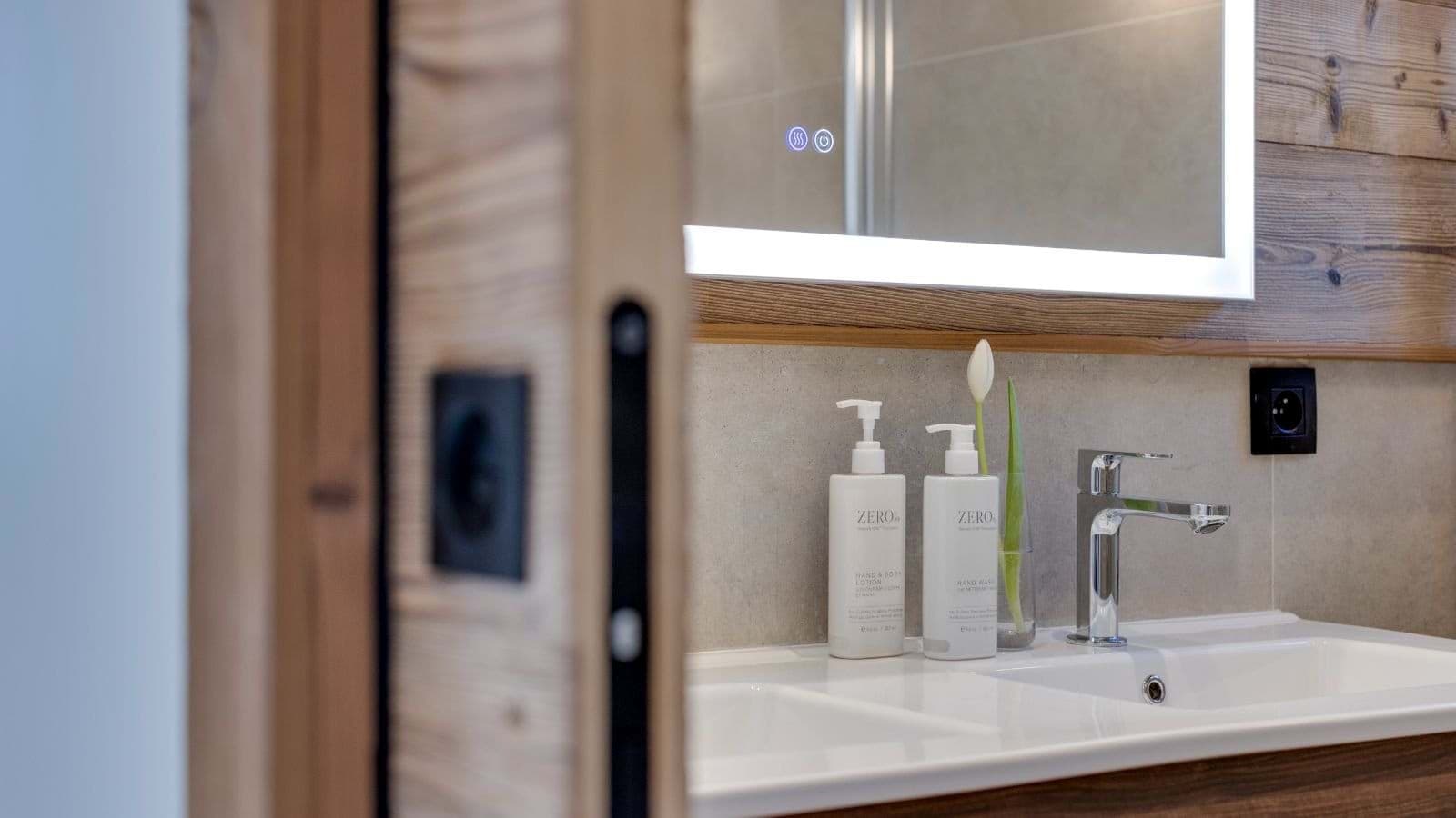 Bathroom vanity with dual sinks and backlit anti-fog mirror