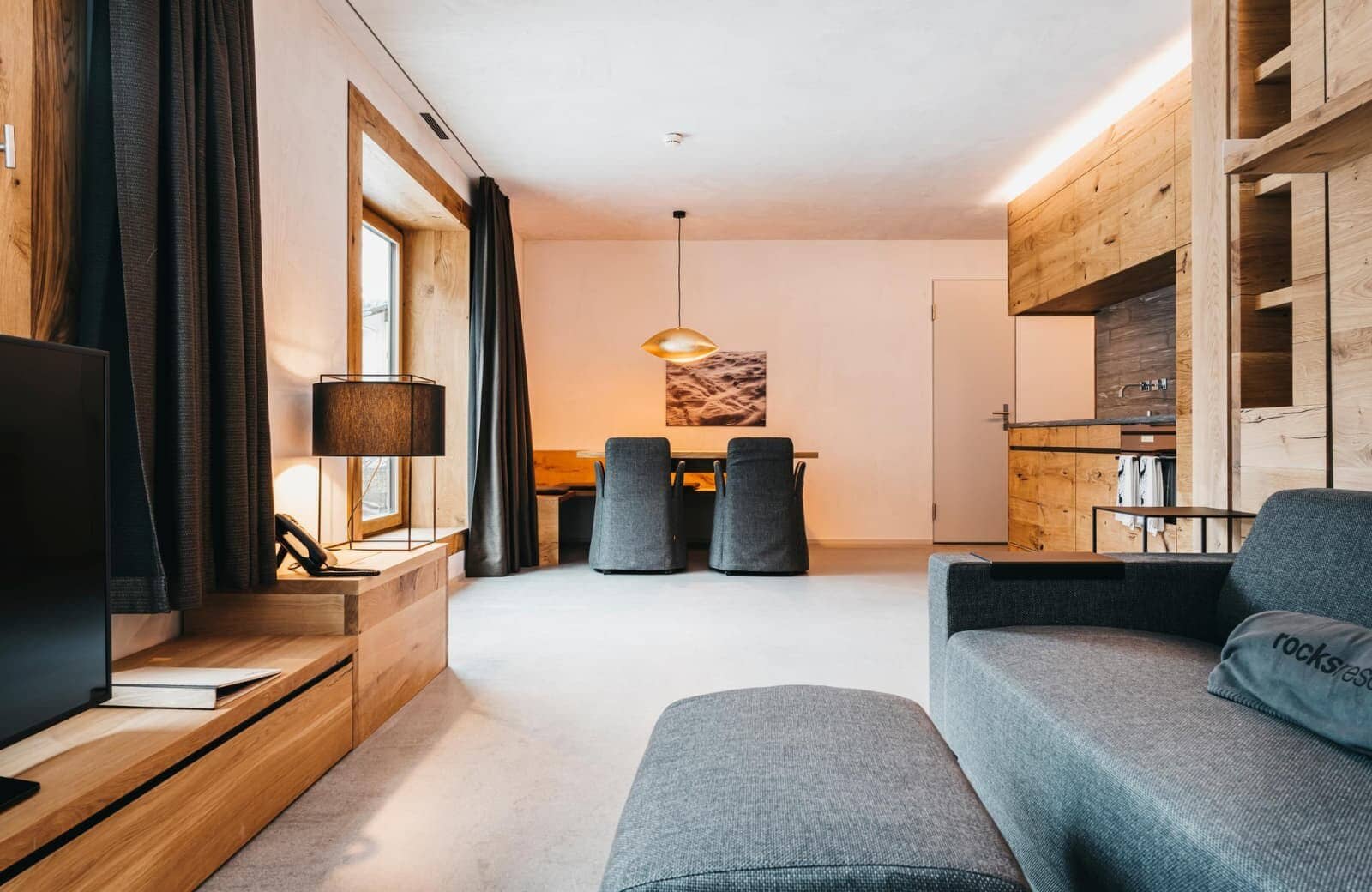 Open-plan living area with integrated kitchen and dining for four