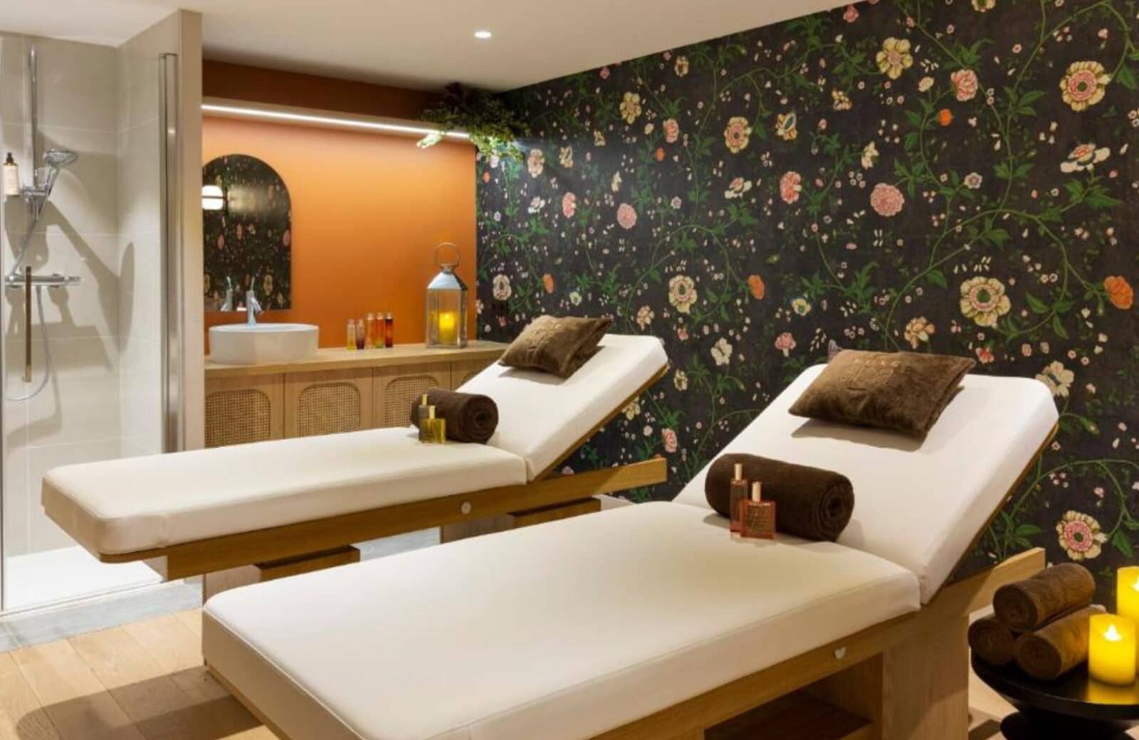 Private treatment room with dual massage tables and walk-in shower