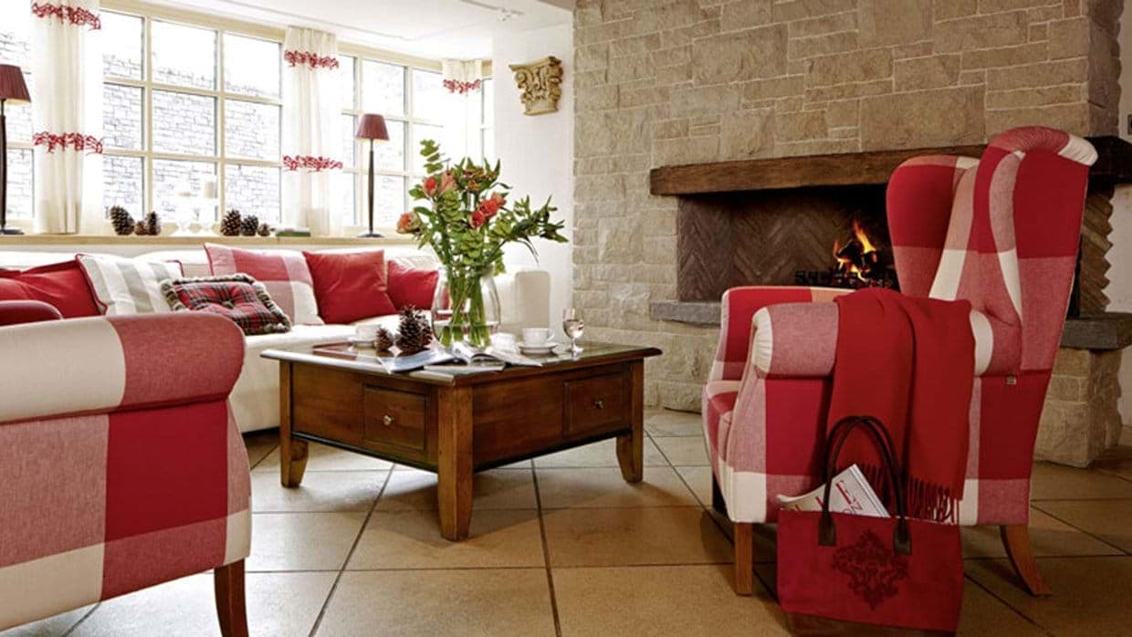 Living area with wood-burning stone fireplace and heated tile floors
