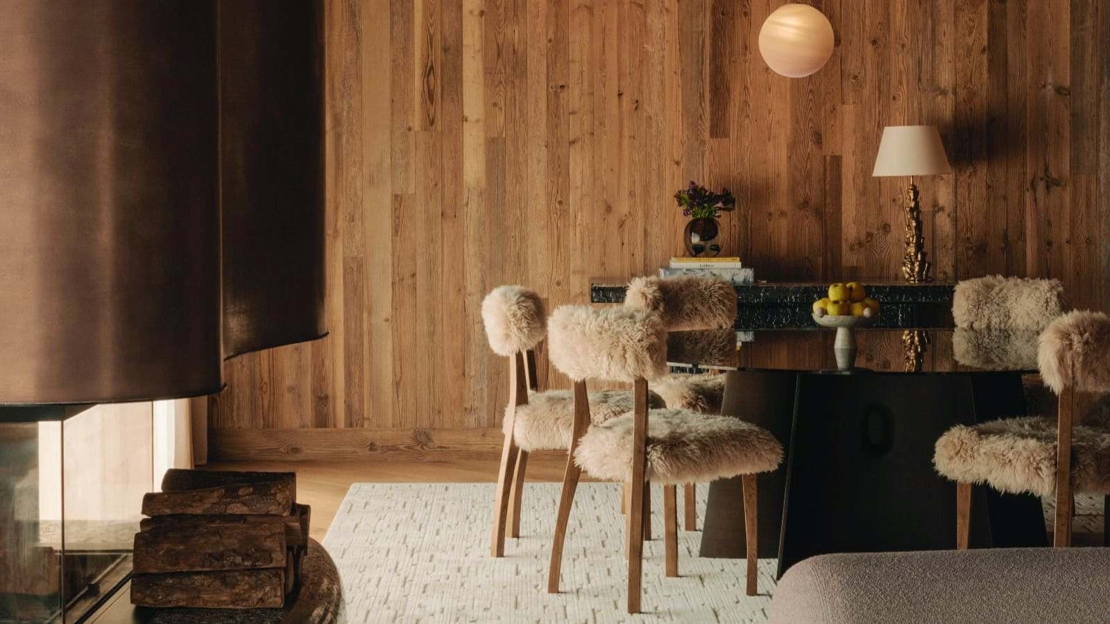 Dining area with wood-paneled walls and wood-burning fireplace