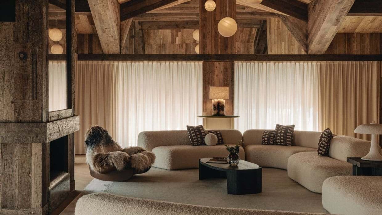 Living area with wood-burning fireplace and curved sectional seating