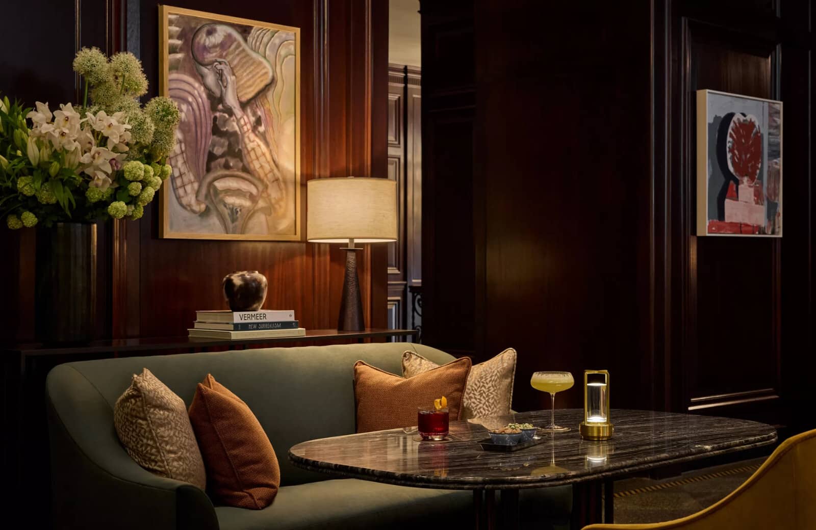 Lounge with dark wood paneling and marble cocktail table