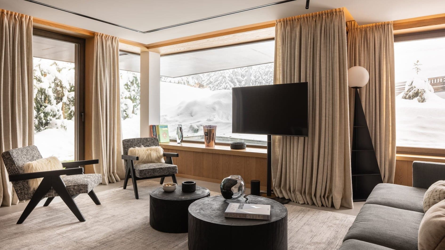 Living area with swivel TV and snow-covered terrace views