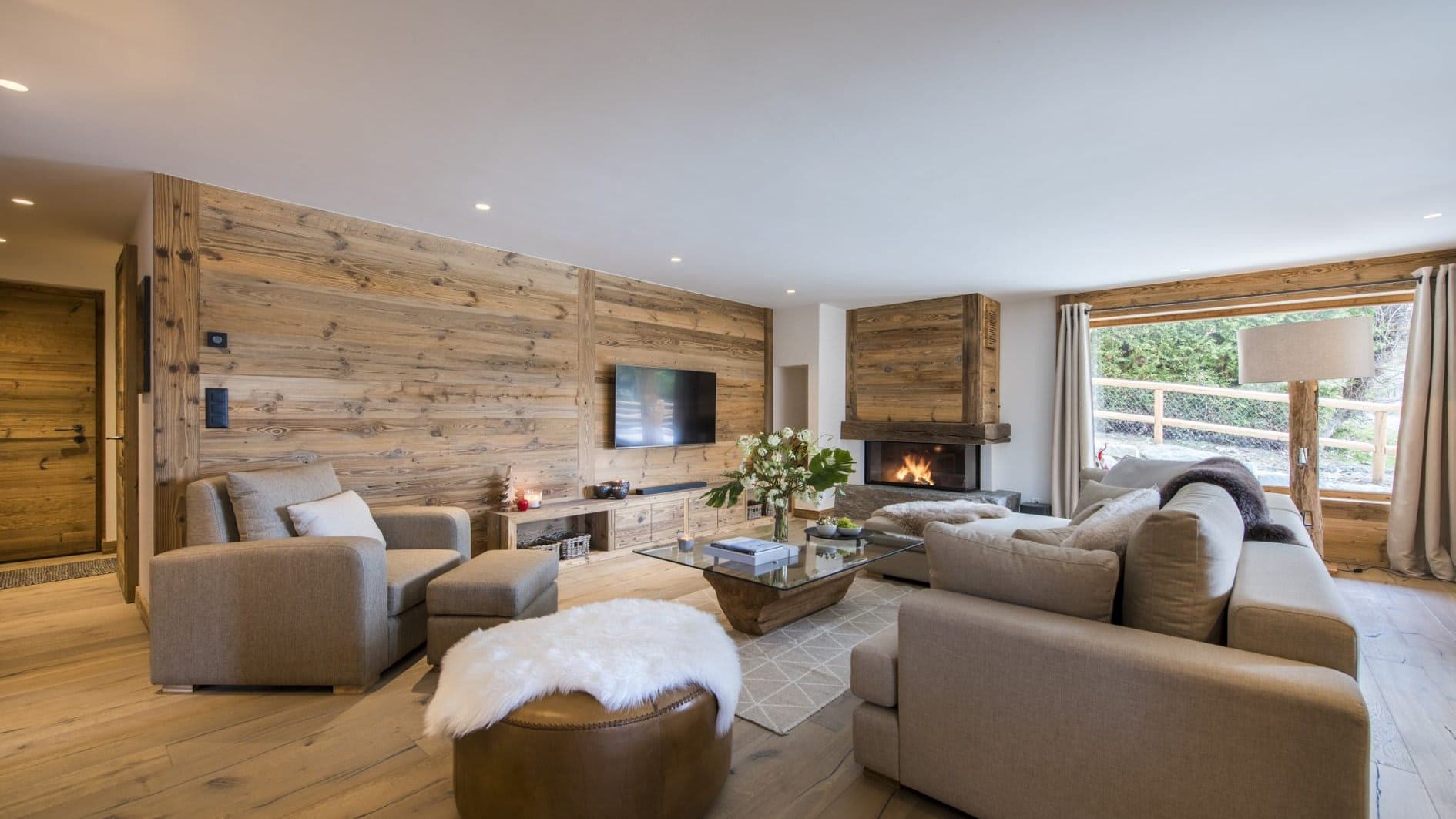Living area with wood-burning fireplace and wall-mounted television