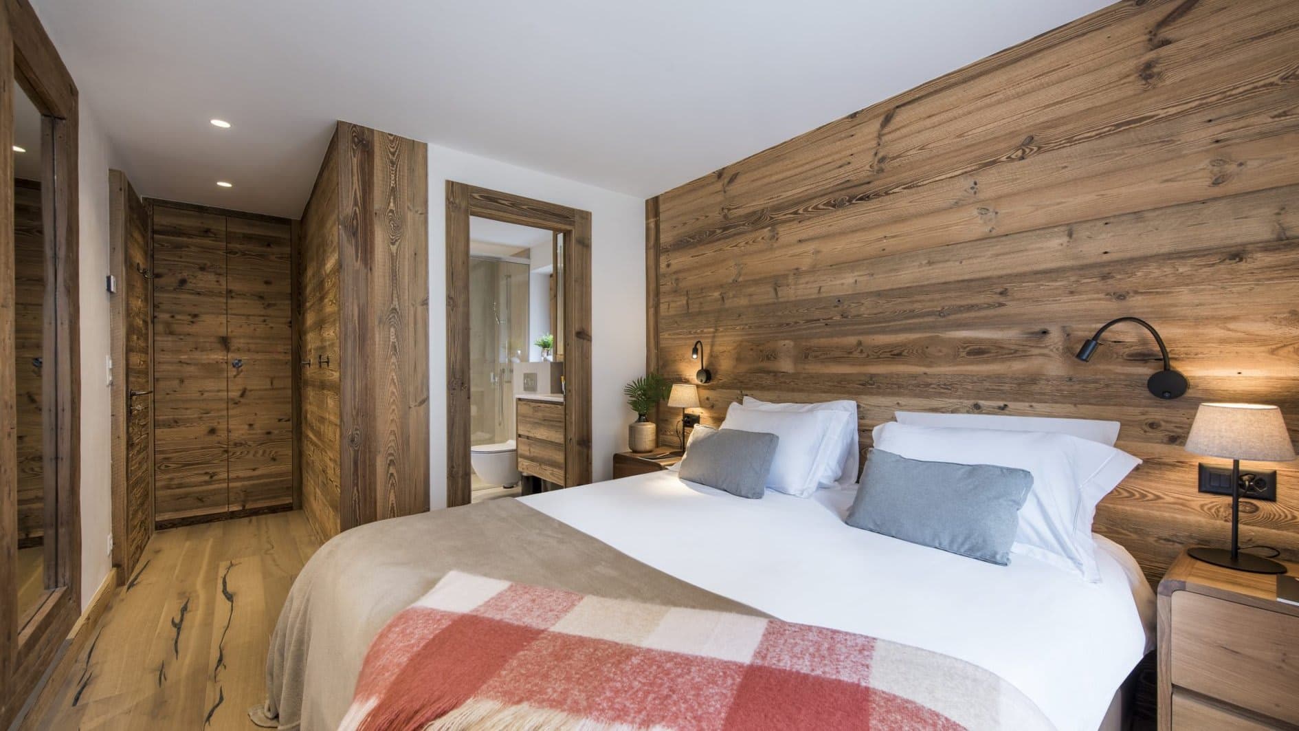 Primary bedroom with ensuite bathroom and built-in wood wardrobe