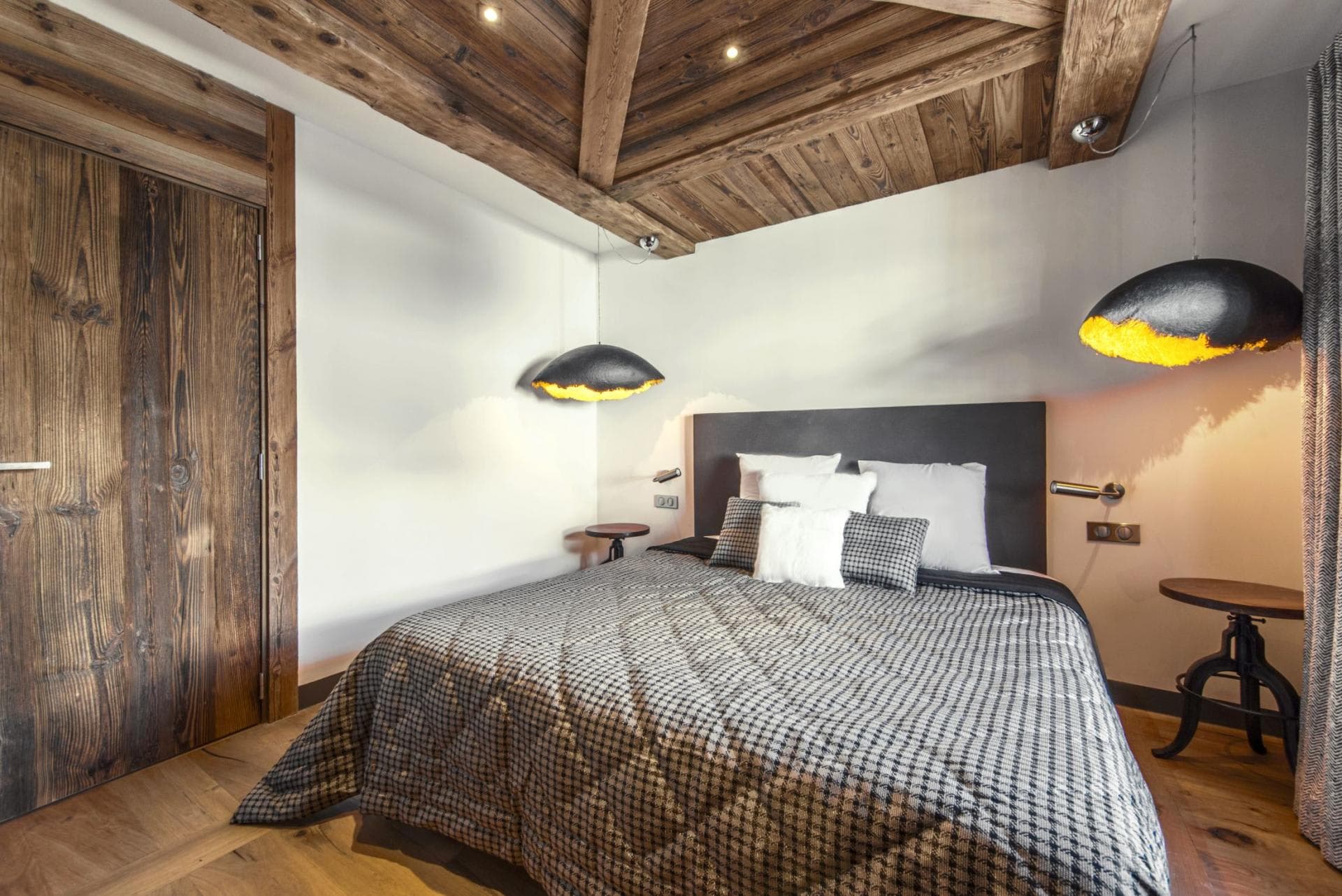 Guest bedroom with king bed, reclaimed wood ceiling, and bedside reading lights