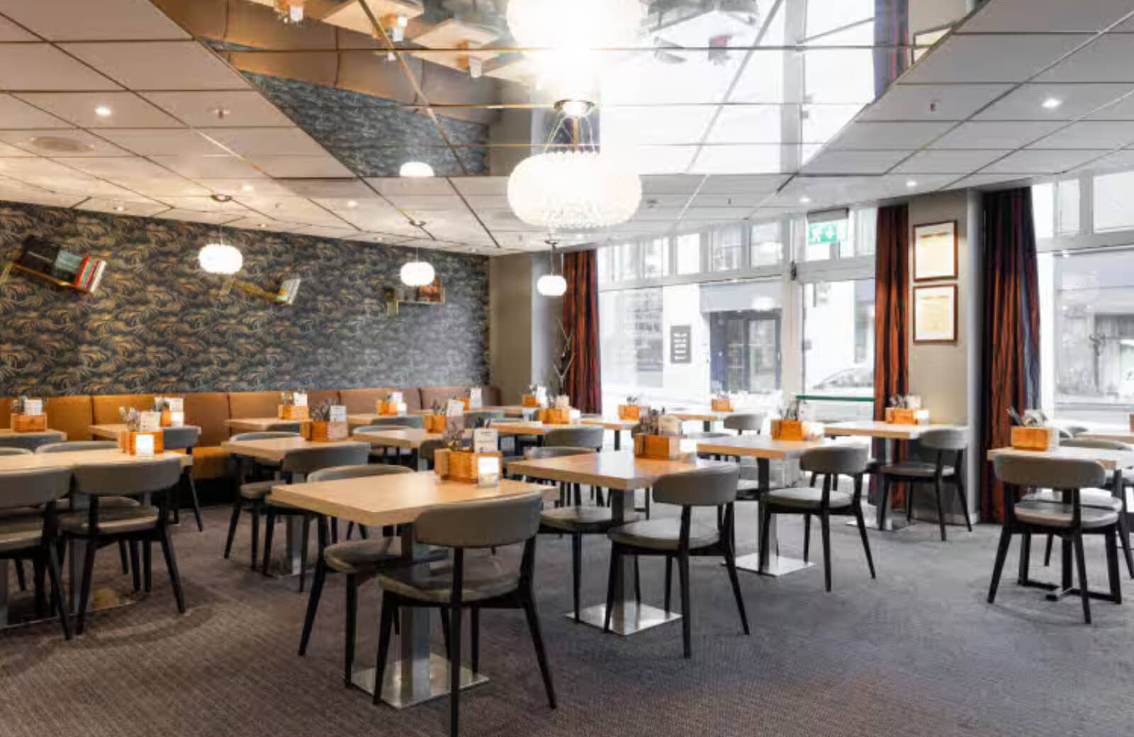 On-site dining area with mirrored ceiling and banquette seating