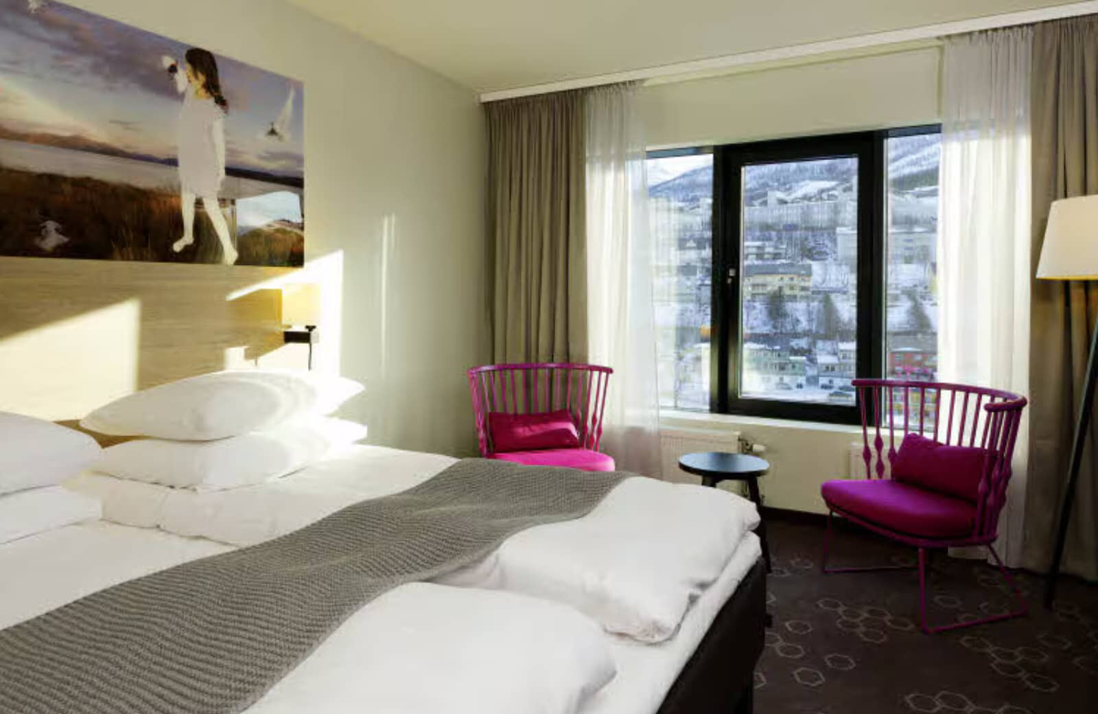 Guest bedroom with two twin beds and mountain village views