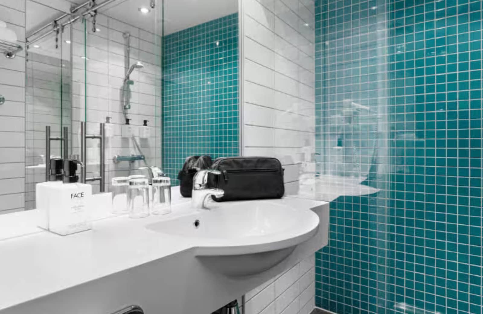 Bathroom vanity and walk-in shower with turquoise tile