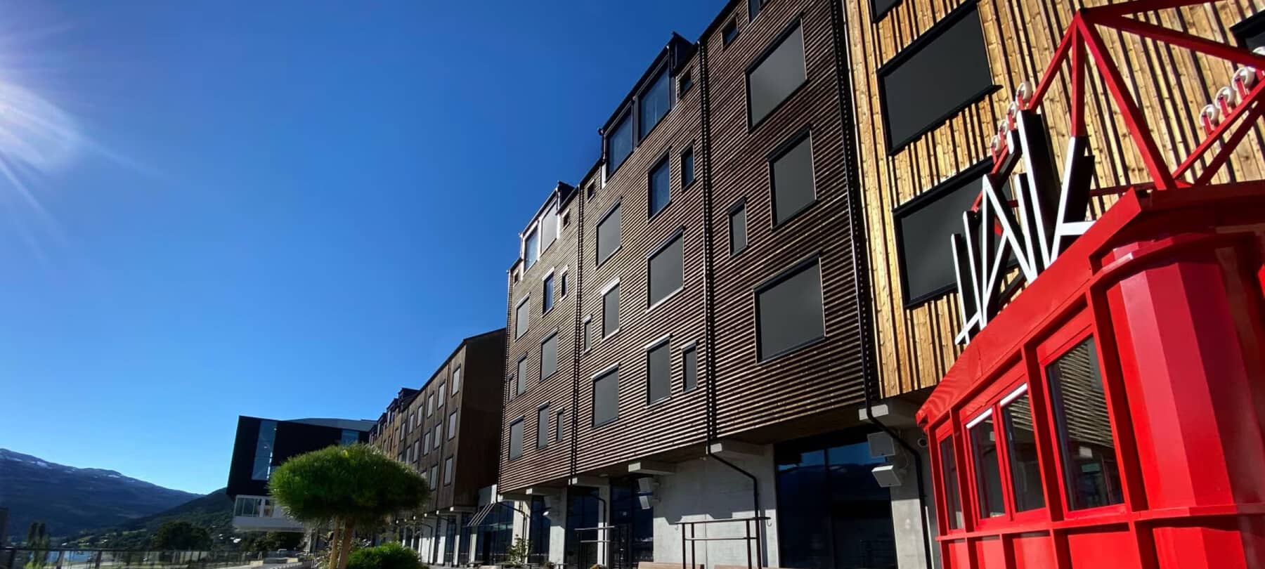 Building exterior with timber cladding and street-level access to amenities