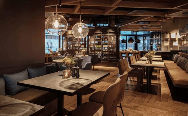 Dining area with parquet floors and floor-to-ceiling wine display