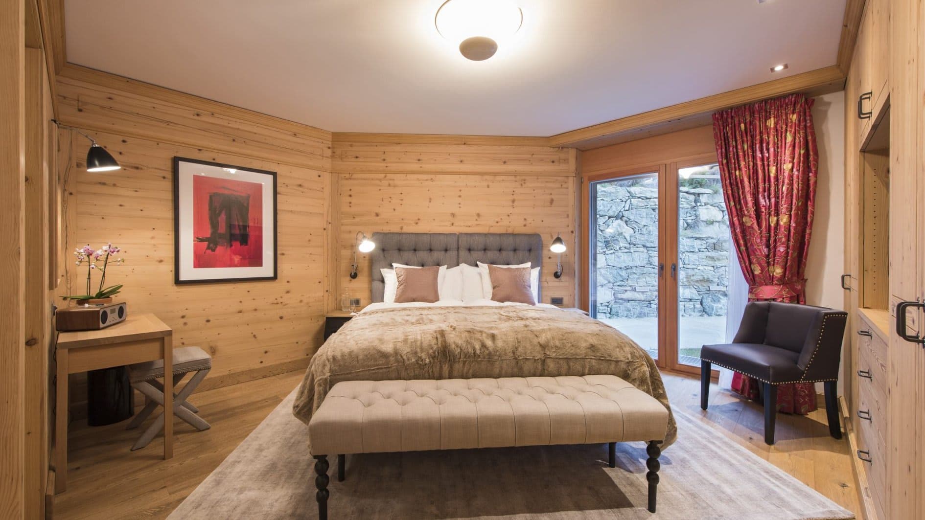 Guest bedroom with king bed, desk, and garden terrace access