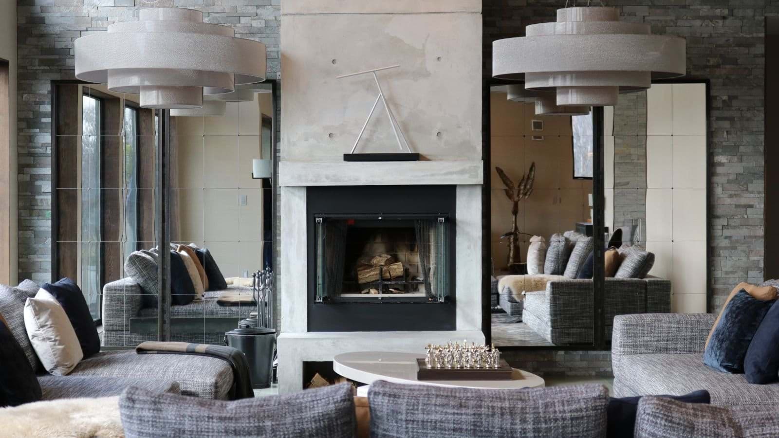 Living area with wood-burning fireplace and tiered pendant lighting