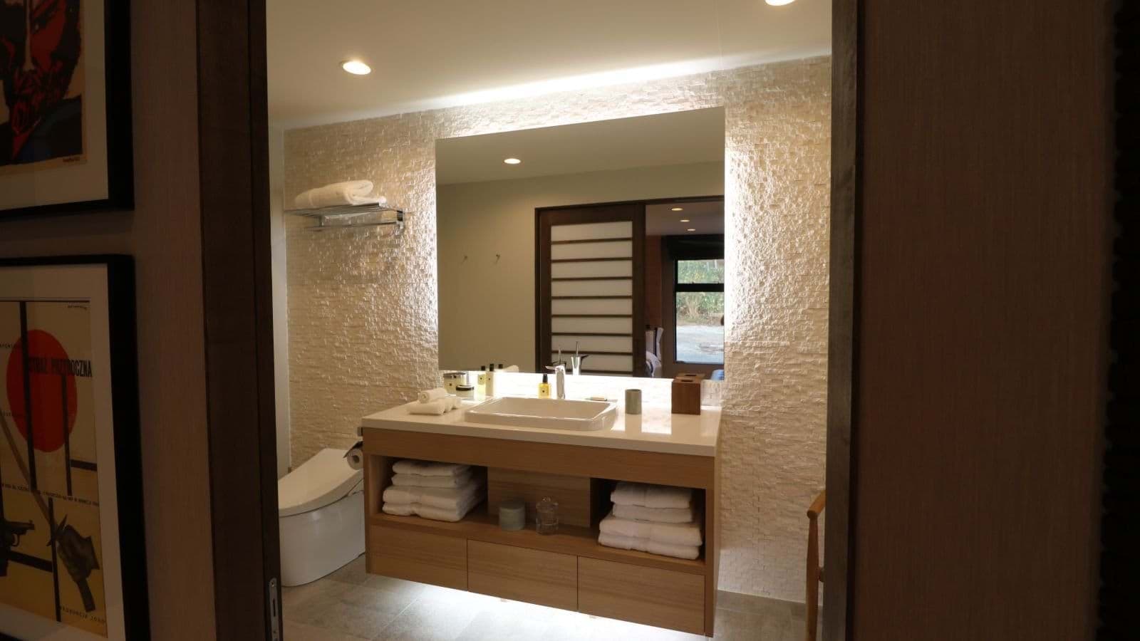 Bathroom with floating vanity and bidet-style washlet toilet