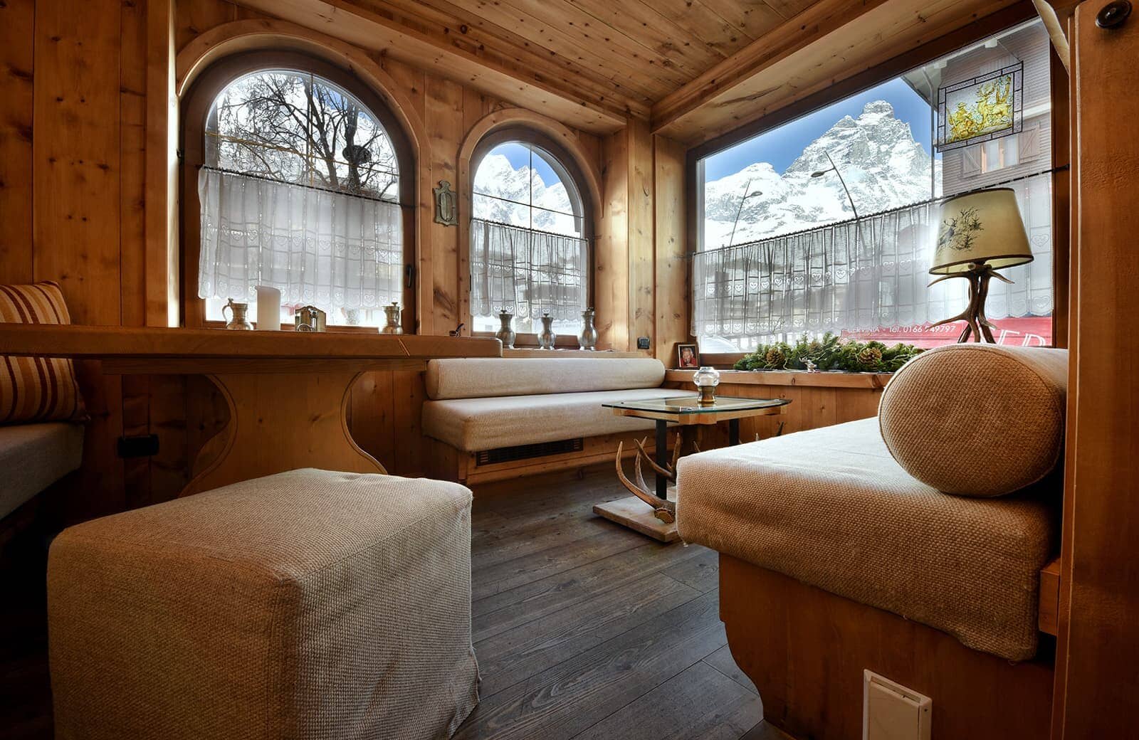 Wood-paneled lounge with built-in seating and Matterhorn views