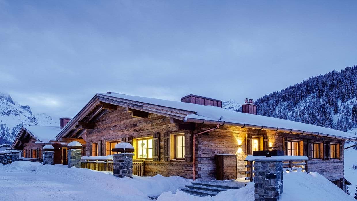 Ski-in chalet exterior featuring reclaimed wood siding and mountain views