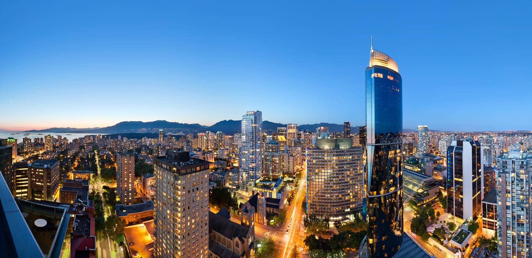 Panoramic balcony view of Vancouver skyline and North Shore mountains