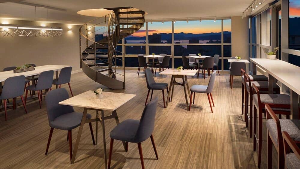 Shared lounge area with sunset mountain views and spiral staircase